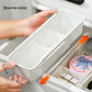 Narrow white drawer organizer box measuring 9 cm wide and 5.5 cm tall held in two hands