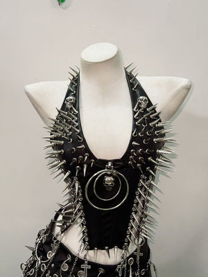 Black faux leather punk vest with silver spikes and skull O-ring pendant on mannequin, front view