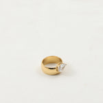 Drop zircon gold-plated ring, front view of the faceted arc stone on the band