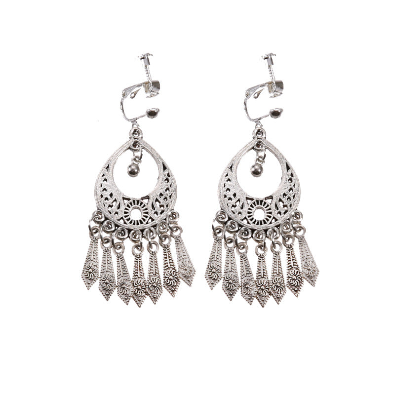 Handmade bohemian clip-on earrings with tassel and bead drop detail, zinc alloy frame, studio shot on white background