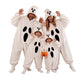 Four people in matching white plush ghost onesies posing together on a plain white background