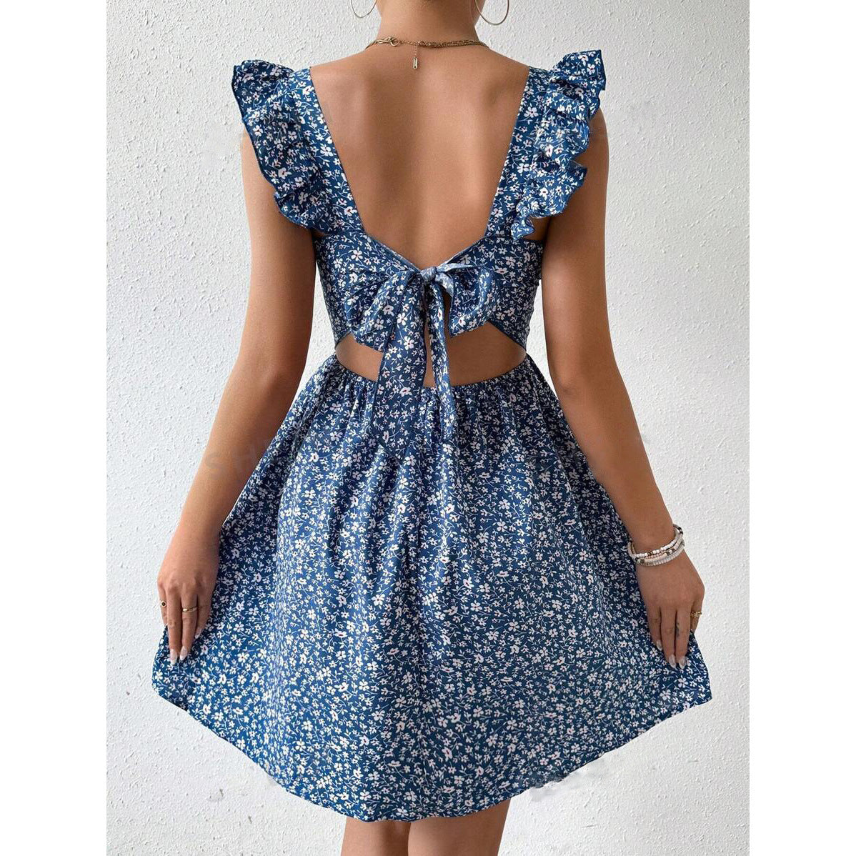 Floral square neck ruffle strap mini dress with a shirred bodice on a standing model, front view
