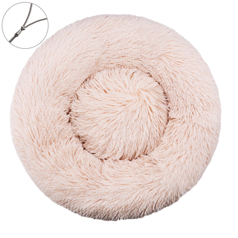 Light beige round plush pet bed with a raised bolster rim on a plain background