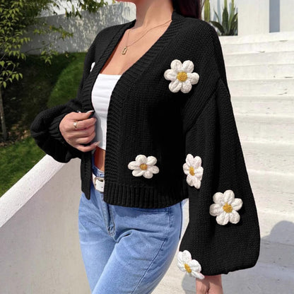 Black open front floral knit cardigan with lantern sleeves, front view on a model over a white top