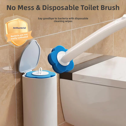 Disposable toilet brush with a blue flower shaped sponge head beside a wall mounted holder with an open flip lid
