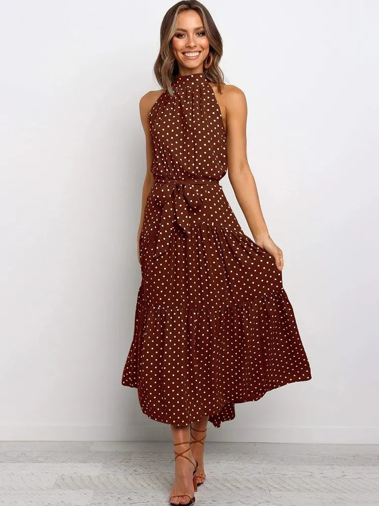 Brown polka dot halter neck sleeveless tiered swing maxi dress worn by a model