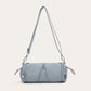 Blue cylindrical nylon crossbody bag with stitched front lines and silver hooks, variant image for the blue color