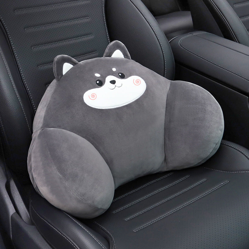 Gray dog lumbar support pillow with a white muzzle resting on a black car seat