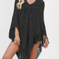 Openwork knit fringe poncho falling open over the arms with a collared tie neckline