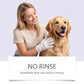 Smiling woman wearing a white glove wipe while stroking a golden retriever, with the words no rinse below
