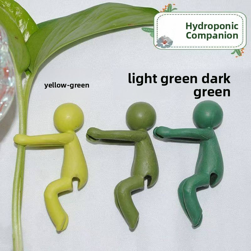 Three green plastic figures in light, olive and dark green with a plant leaf above, Hydroponic Companion caption