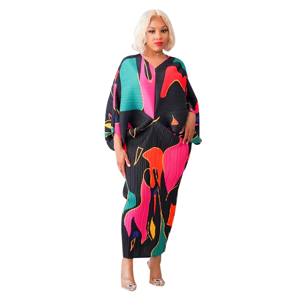 Pleated batwing V neck abstract print midi dress on a standing model, back view