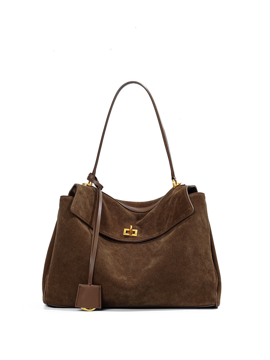 Detail of stitching, hardware and finish on the frosted suede leather tote
