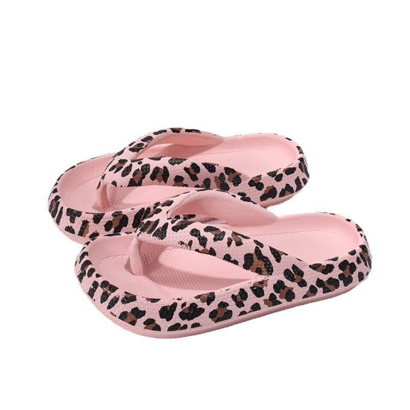 Close up of the toe post strap and leopard print footbed of the flip flops
