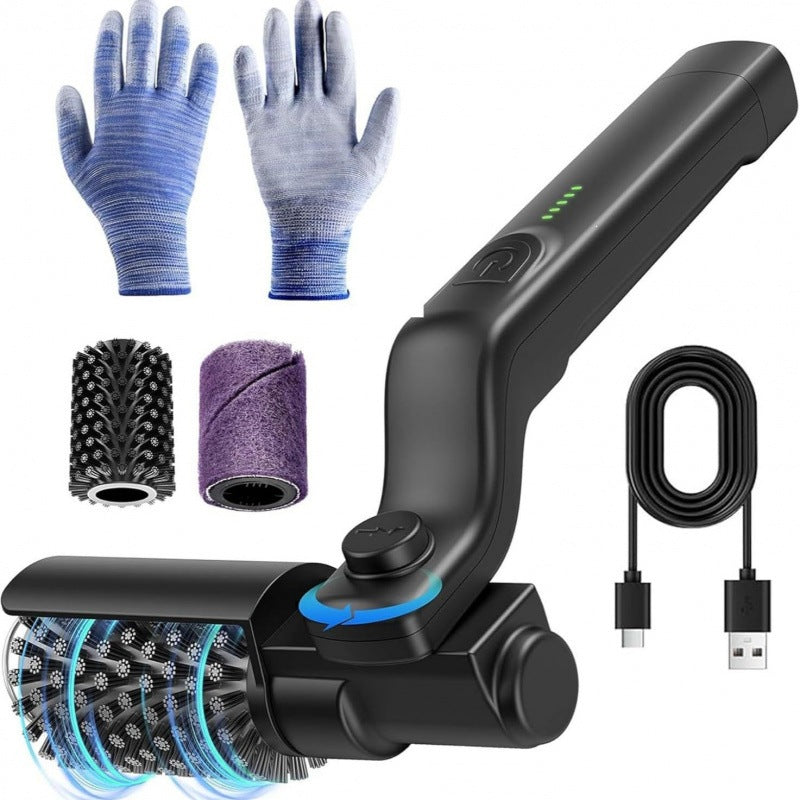 Gloved hand holding the electric grill brush with its spinning roller and USB cable