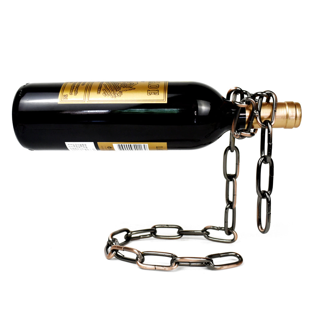 Antique bronze iron chain holding a wine bottle level above a coiled chain base on a white background