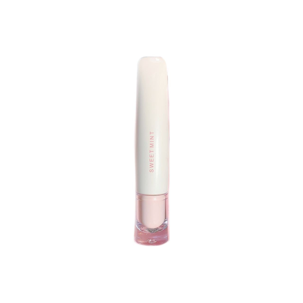Single cream lip glaze tube standing upright with a clear applicator base on a white background