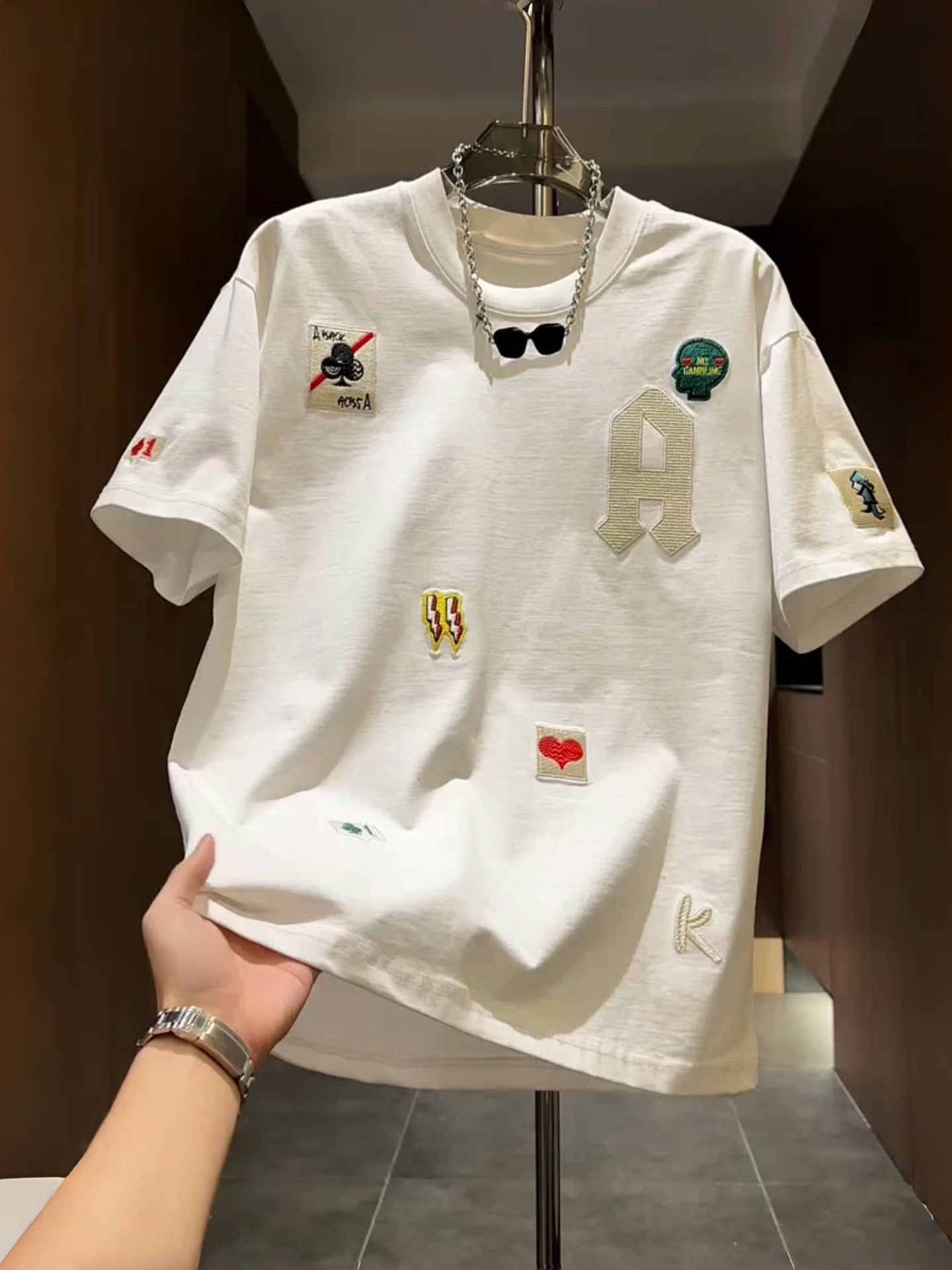 Men's loose fit embroidered patch T-shirt in white with a varsity A letter and sewn on patches
