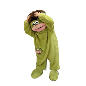 Studio view of the green monster onesie showing the front zip below the hip pocket and the leg hems