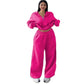 Model wearing the hot pink cropped half-zip sweatshirt and wide-leg sweatpants set, front view