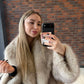 Oatmeal vegan fur short jacket with dark tipped pile and wide collar, mirror selfie
