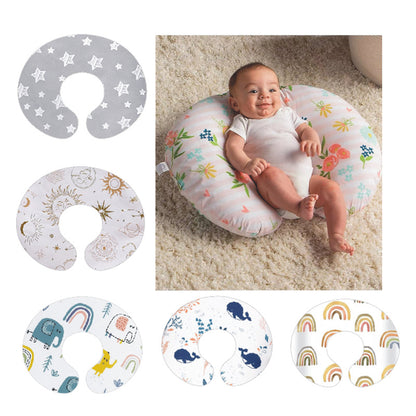 Six nursing pillow cover designs in stars, suns, elephants, whales and rainbows beside a baby lying on a floral pillow