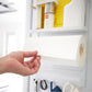 Magnetic fridge side rack shelf holding condiment jars and a bottle of oil