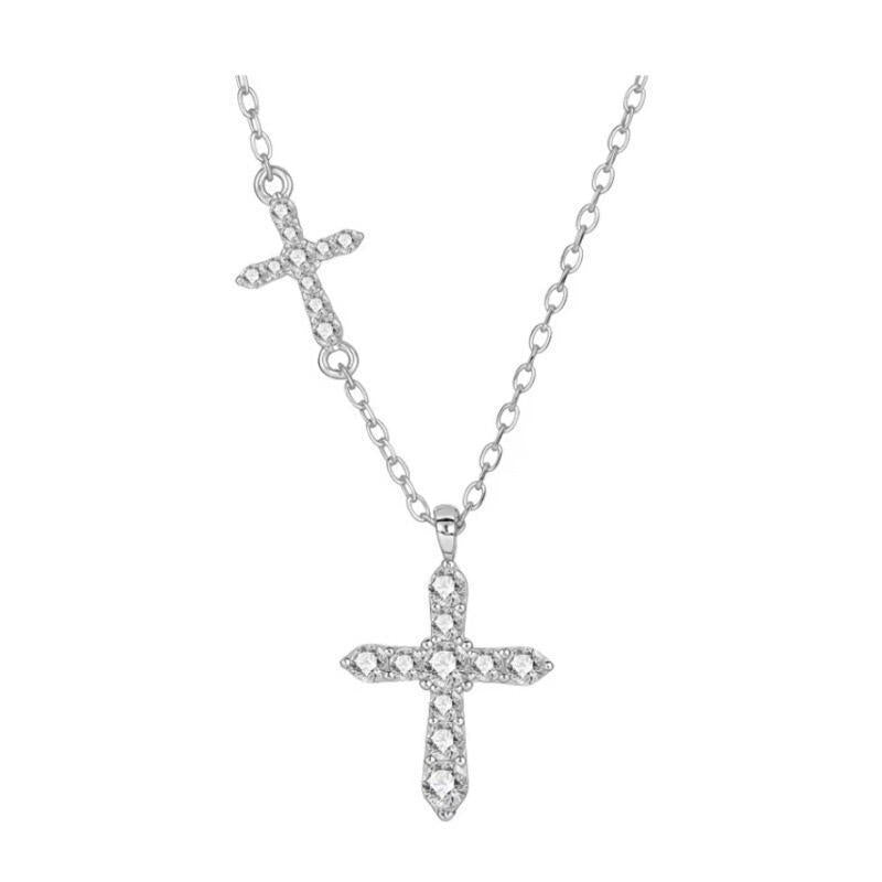 Small cross set into the fine cable chain above the hanging cross pendant