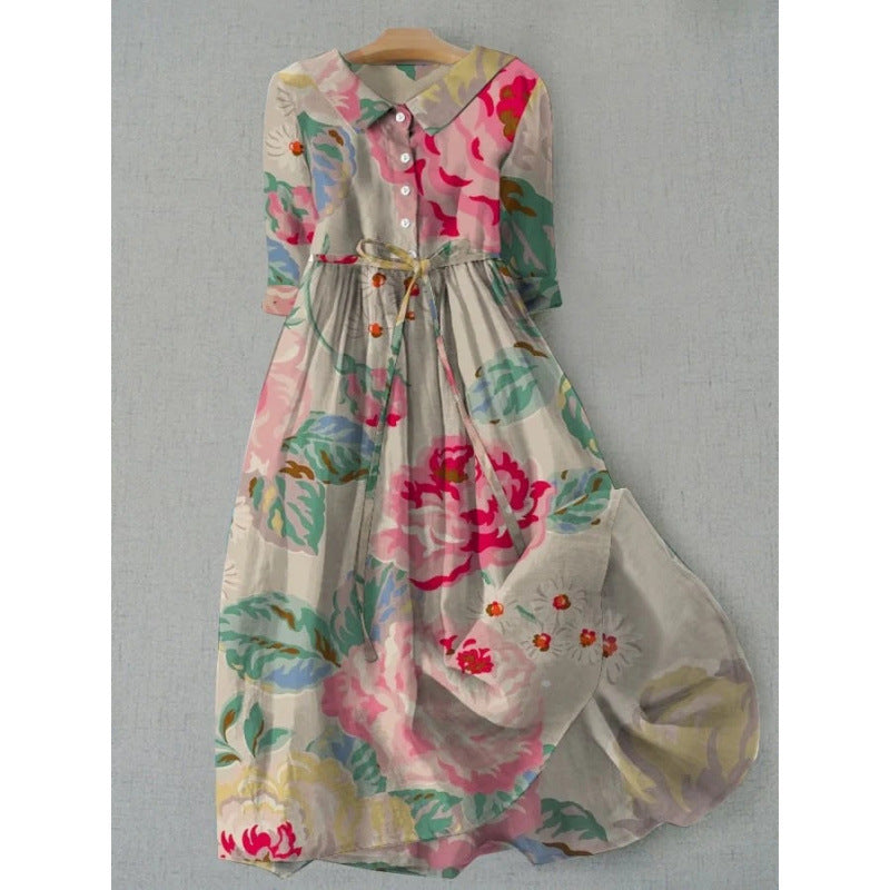 Vintage style floral midi dress with a tie waist and doll collar shown from the front