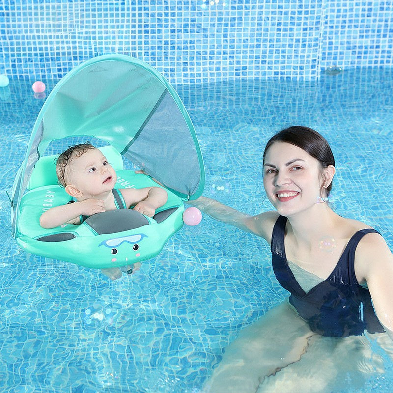 Mint baby swim float with canopy raised in a pool, baby aboard and an adult alongside