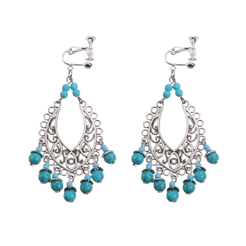 Boho vintage clip-on drop earrings with fringe and bead accents, zinc alloy build, studio image on white background