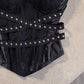 Molded sweetheart cups of the strapless black bustier over a lace textured boned body