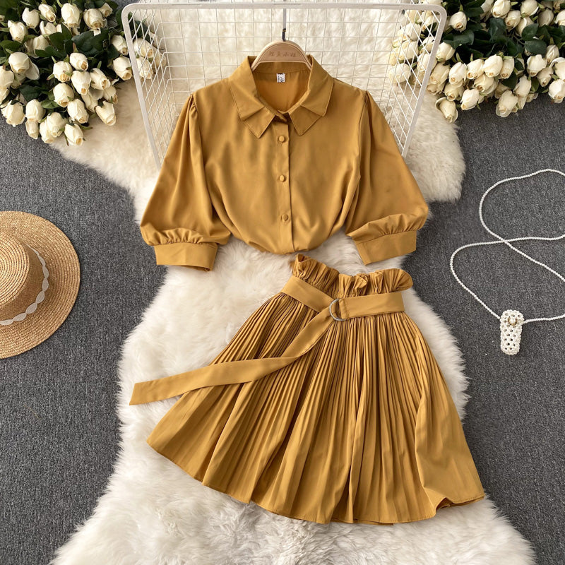 Short-sleeve shirt and skirt set styled together in an angled view