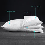Two adjustable down bed pillows stacked, one lofted and one flat, on a plain background