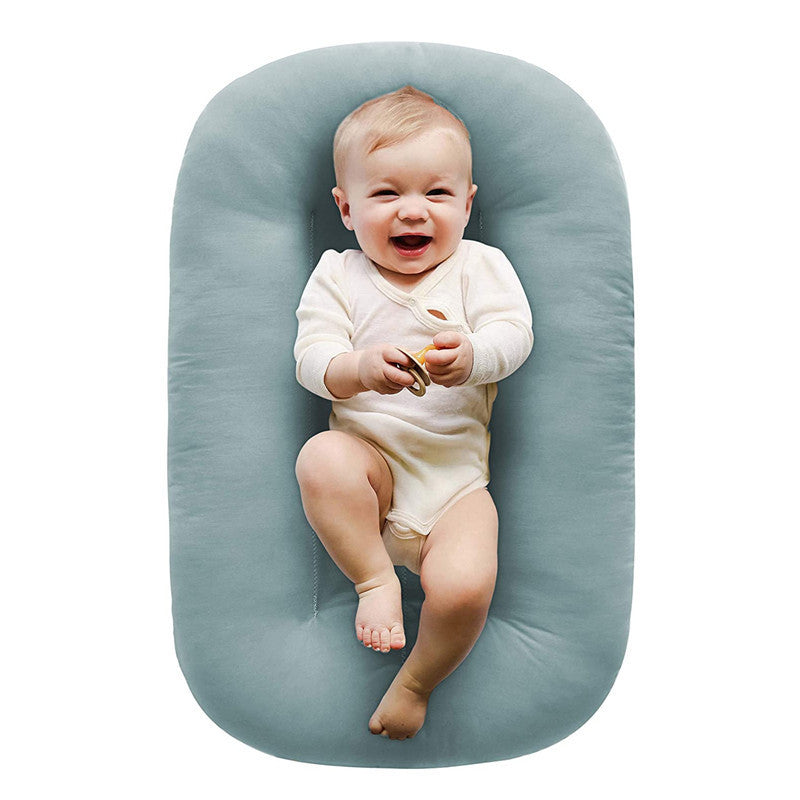 Baby lounger nest styled in an everyday living room scene for supervised lounging