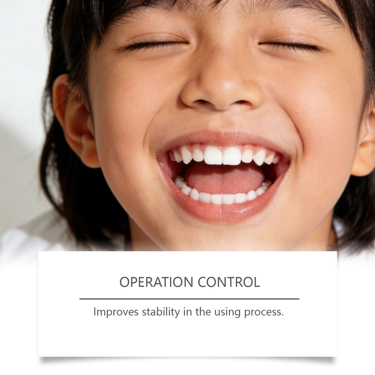 Child smiling to show clean teeth beside the bamboo toothbrush