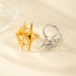 Gold star ring beside a silver ring turned to show the open adjustable band