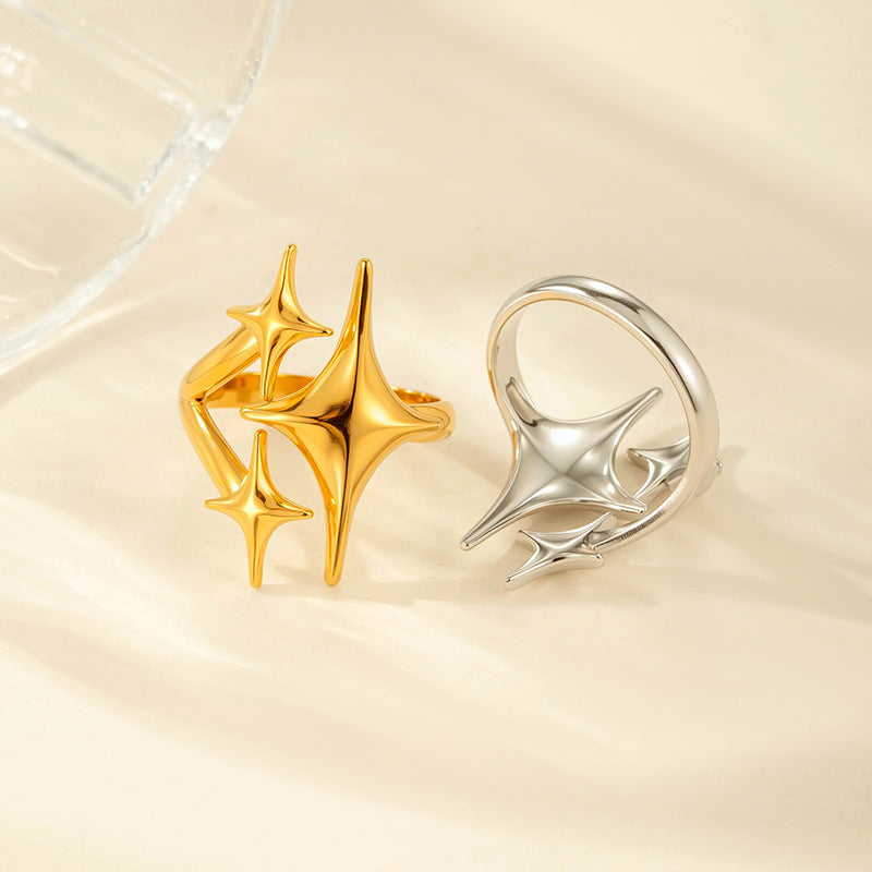 Gold star ring beside a silver ring turned to show the open adjustable band