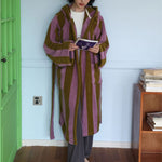 Pink and coffee wide striped hooded cotton terry bathrobe worn long and loose with patch pockets and tie belt