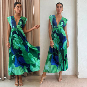 Model wearing the green and blue abstract pleated maxi dress, front view
