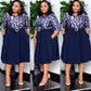 Belted two tone pleated swing midi dress with round neck and half sleeves on a model