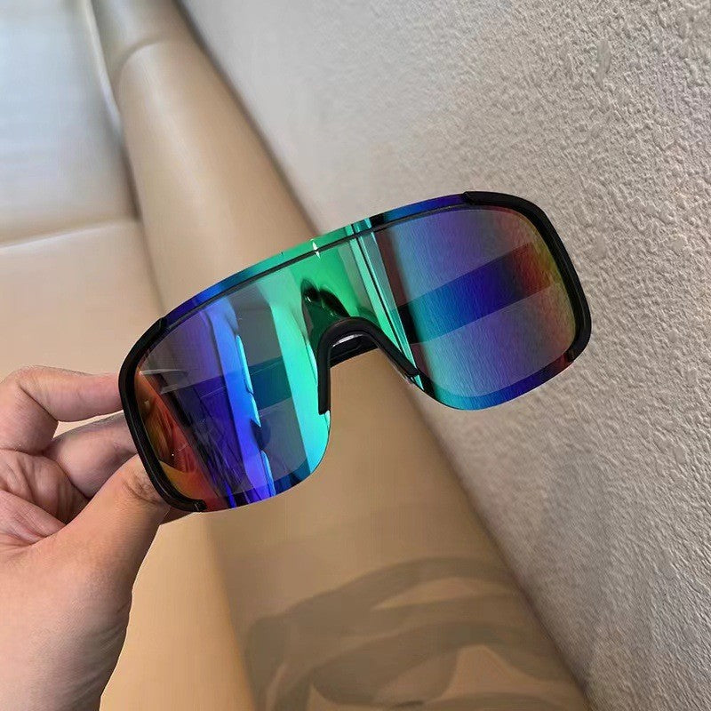 Top view of sports sunglasses next to a hiking water bottle