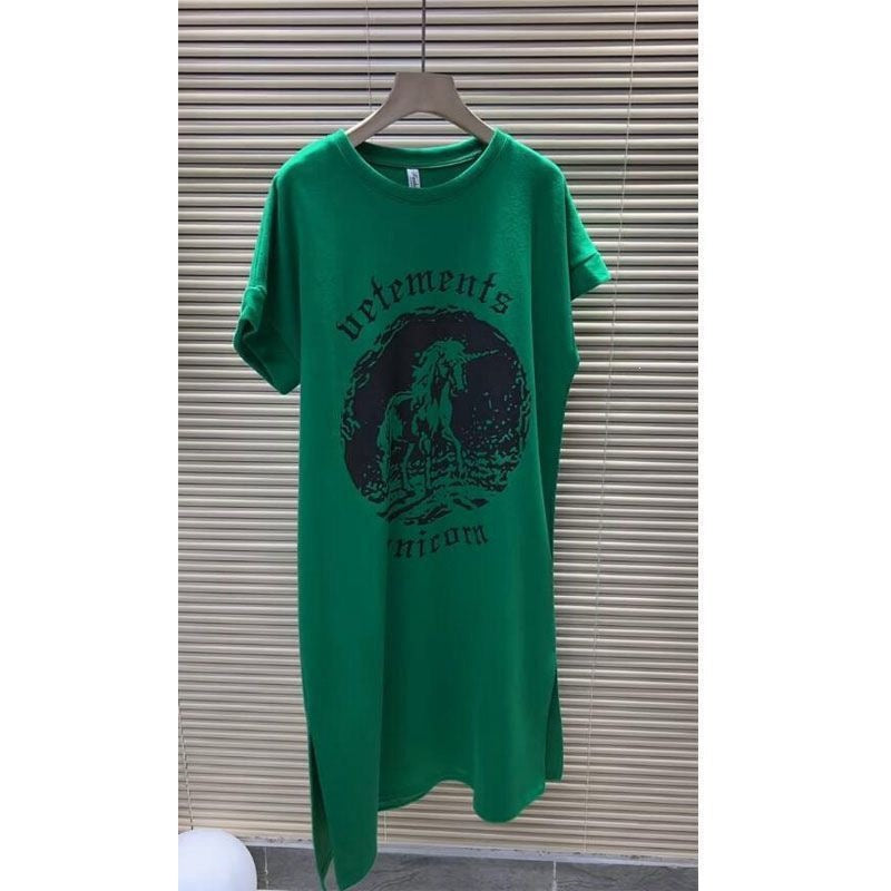 Loose green jersey dress with rearing unicorn medallion print across the front