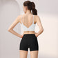 Back view of a woman in a white V-back sports bra and black high-waist shorts set, size L option