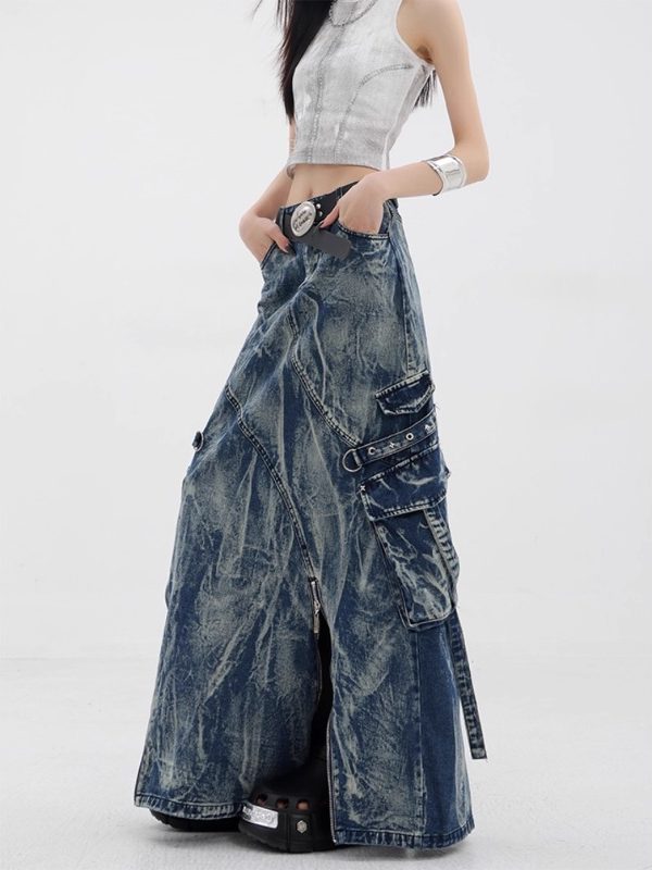 Model resting a hand in the high-waist pocket of the marbled denim maxi skirt with exposed front zippers