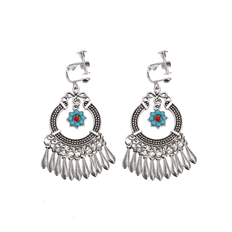 Handmade bohemian clip-on earrings with tassel and bead drop detail, zinc alloy frame, studio shot on white background