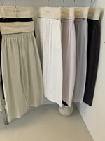 Cotton wide leg trousers on hangers in white, light pink, lilac and carbon ash tones