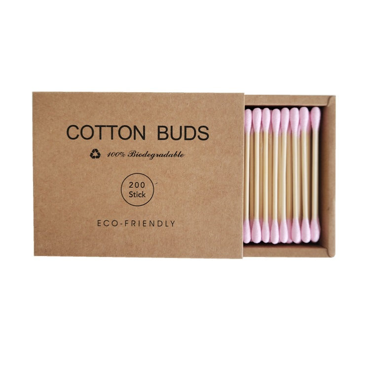 Double-headed makeup swab beside everyday makeup bag and beauty kit essentials