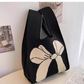Soft knit wrist bag with an open top and a jacquard knitted pattern