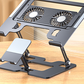 Close view of a dark laptop stand with two round fans and a phone holder on a wooden desk